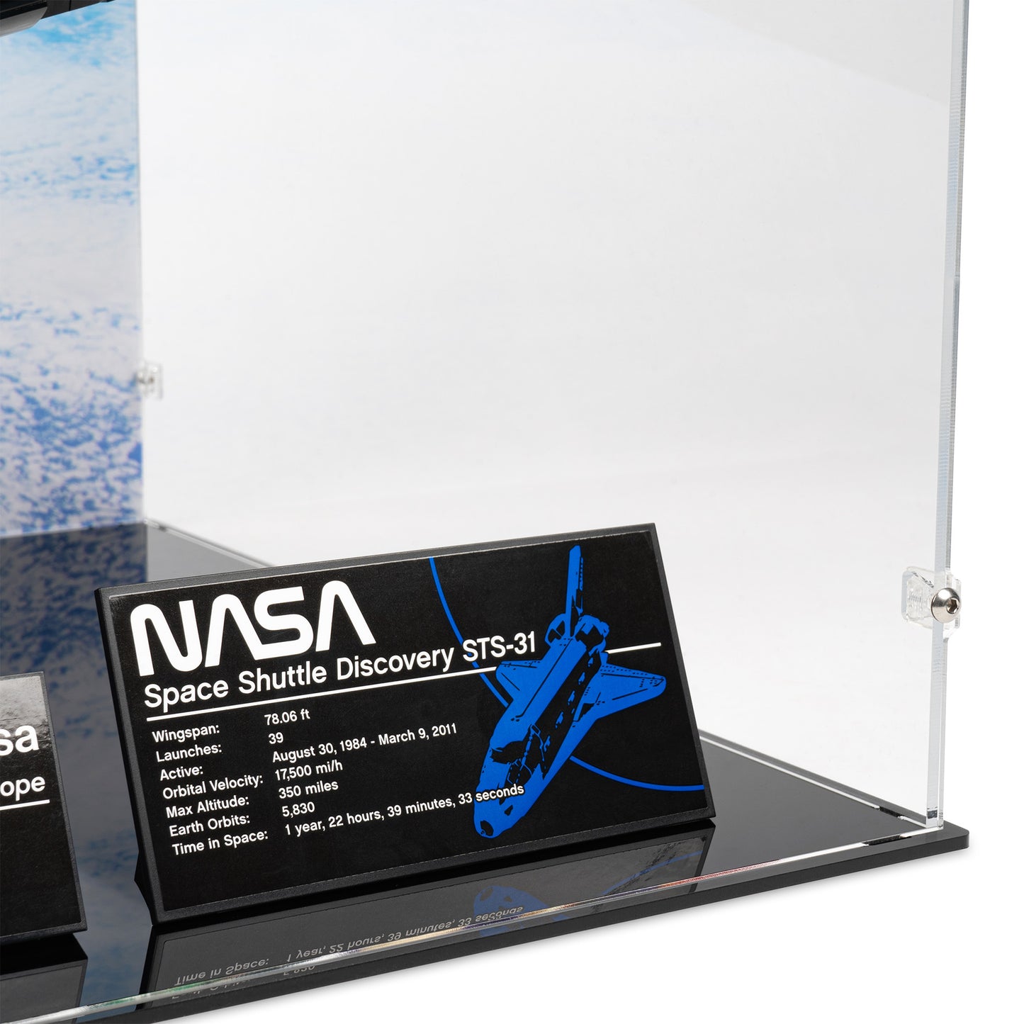 Fitting detail view of LEGO 10283 NASA Space Shuttle Discovery Display Case with a UV printed background.