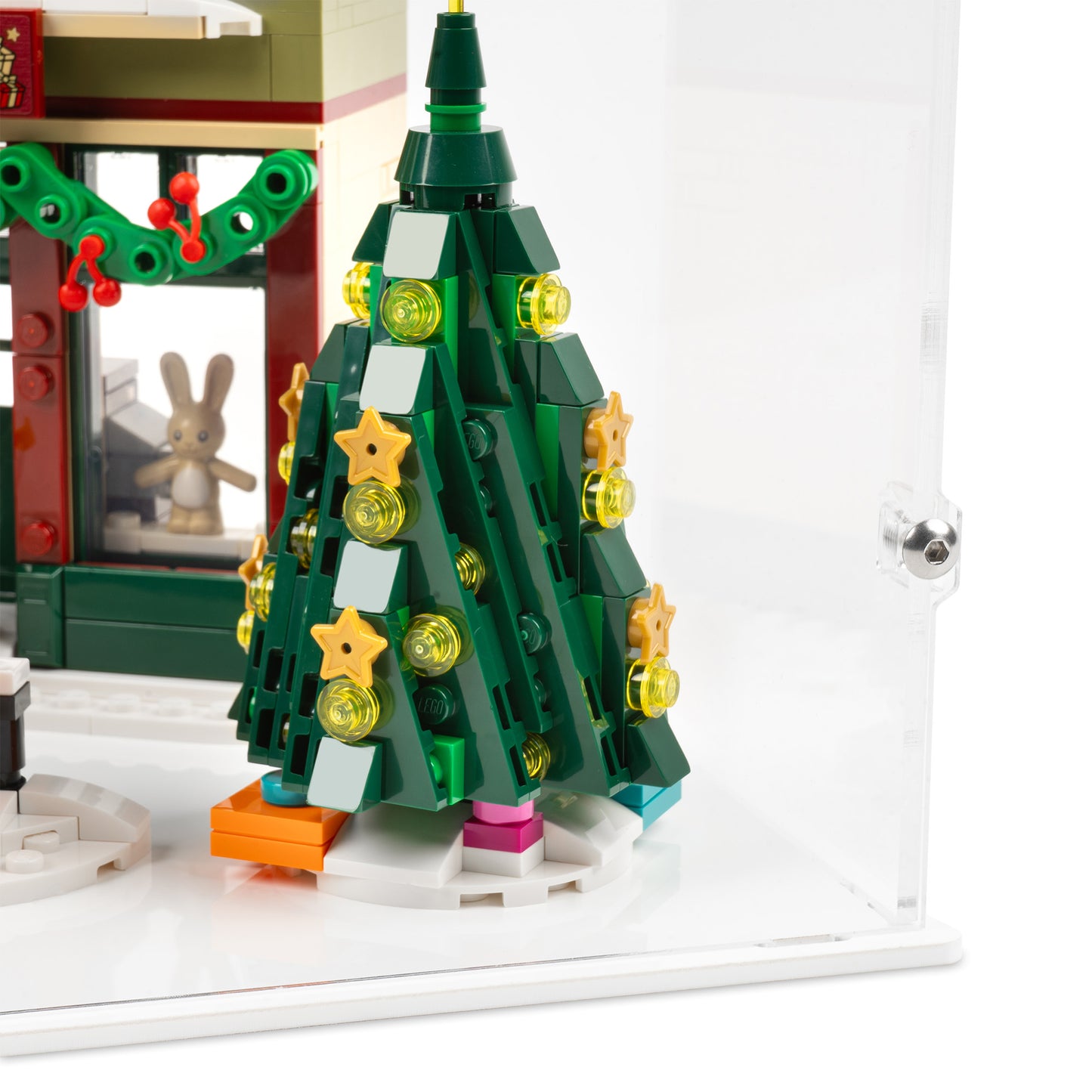 Fitting detail view of LEGO 10308 Holiday Main Street Display Case with a white base.