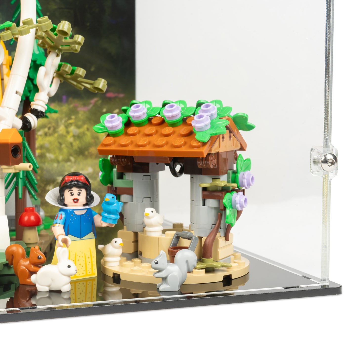 Fitting detail view of LEGO 43242 Snow White and the Seven Dwarfs' Cottage Display Case with a UV printed background.