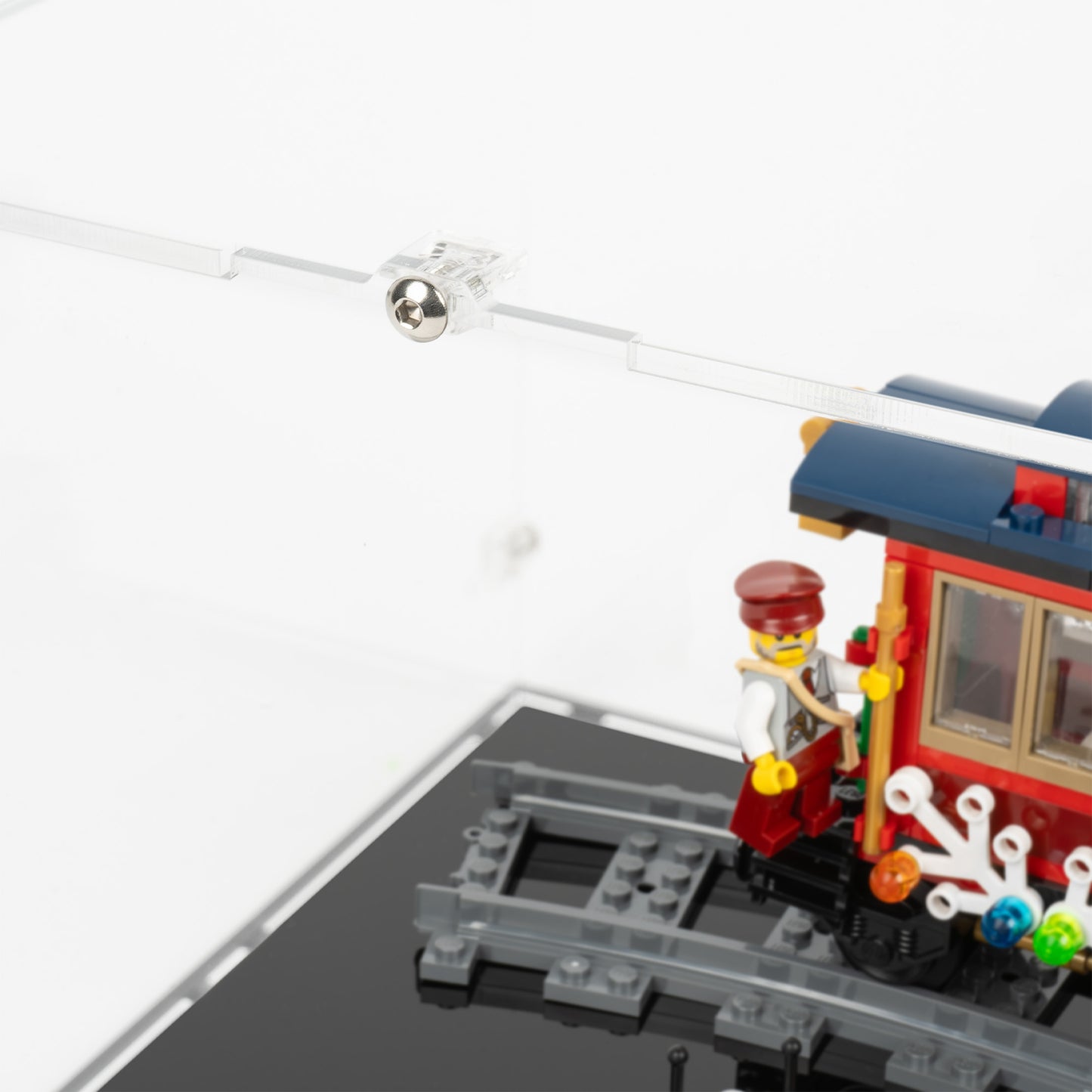 Fitting detail view of LEGO 10254 Winter Holiday Train Display Case with a black base.