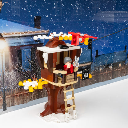 Treehouse detail view of LEGO 21330 Home Alone Display Case with a white base and a UV printed background.