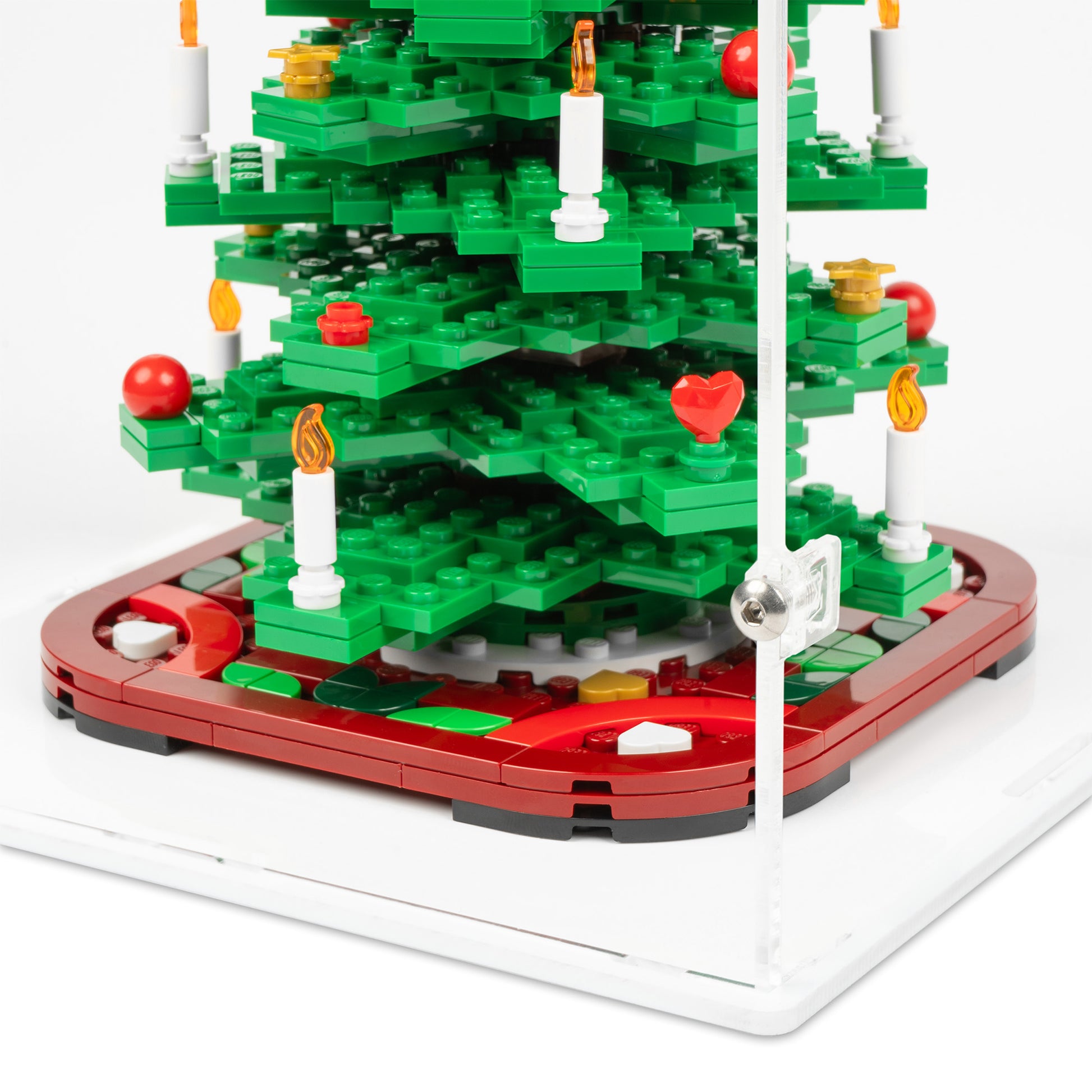 Fitting detail view of LEGO 40573 Christmas Tree Display Case with a white base.